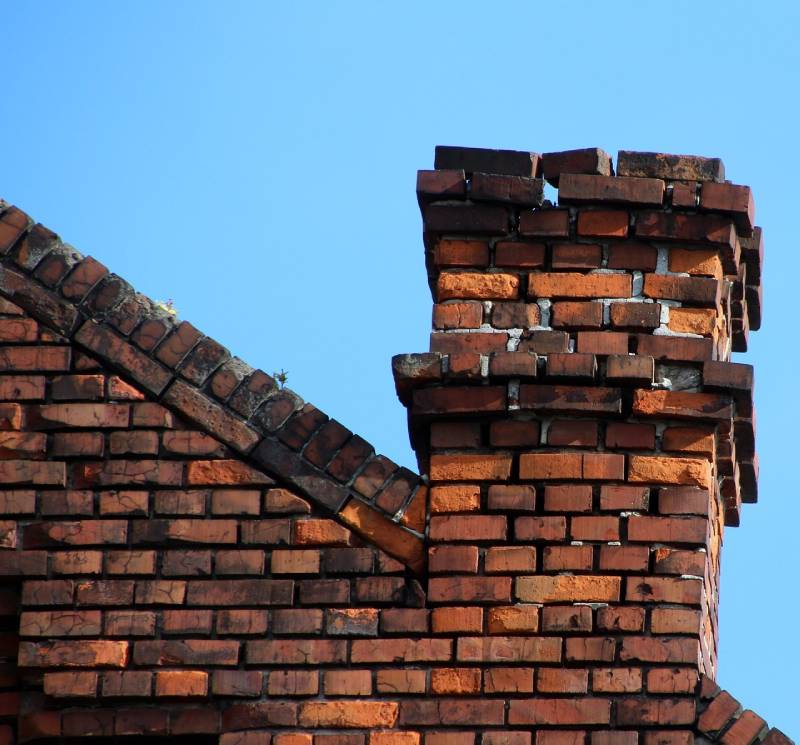 Signs Your Woodlawn Home Needs a Chimney Inspection Damaged chimney on an Woodlawn home showing cracks and missing mortar